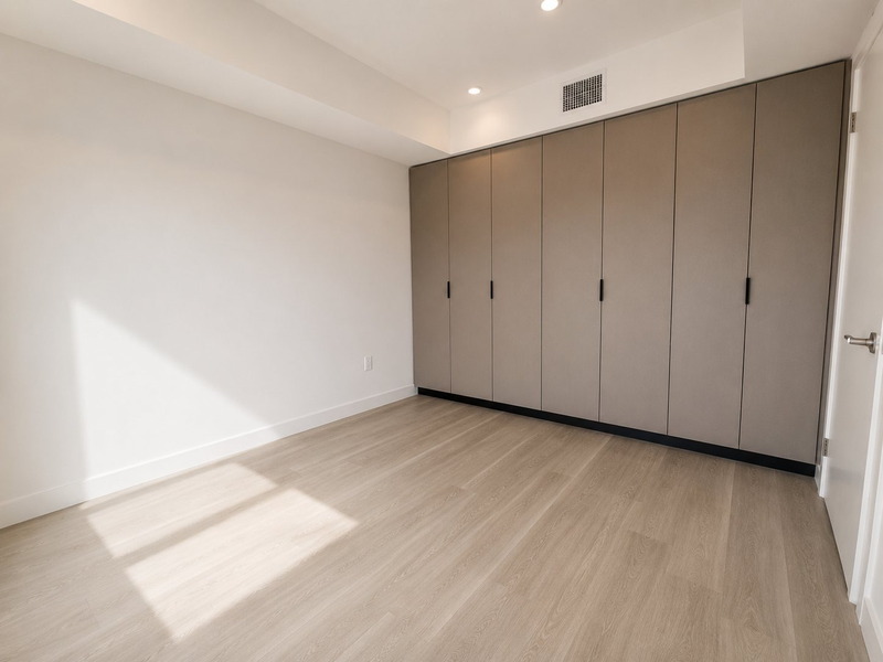 Bedroom with a full wall of built-in wardrobes